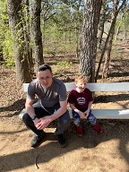 Hudson joins me on the bench as we wait for the rest of our mud-bound party