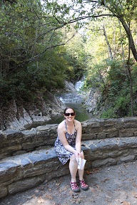 The lovely Jen in front of the waterfall at the end of the path